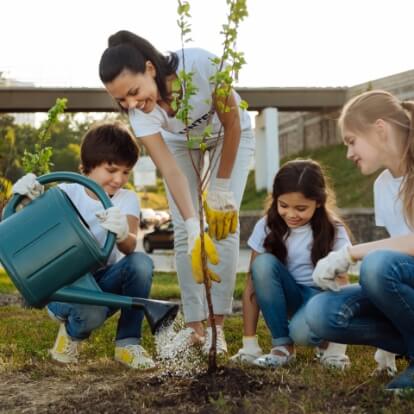 family planting tree